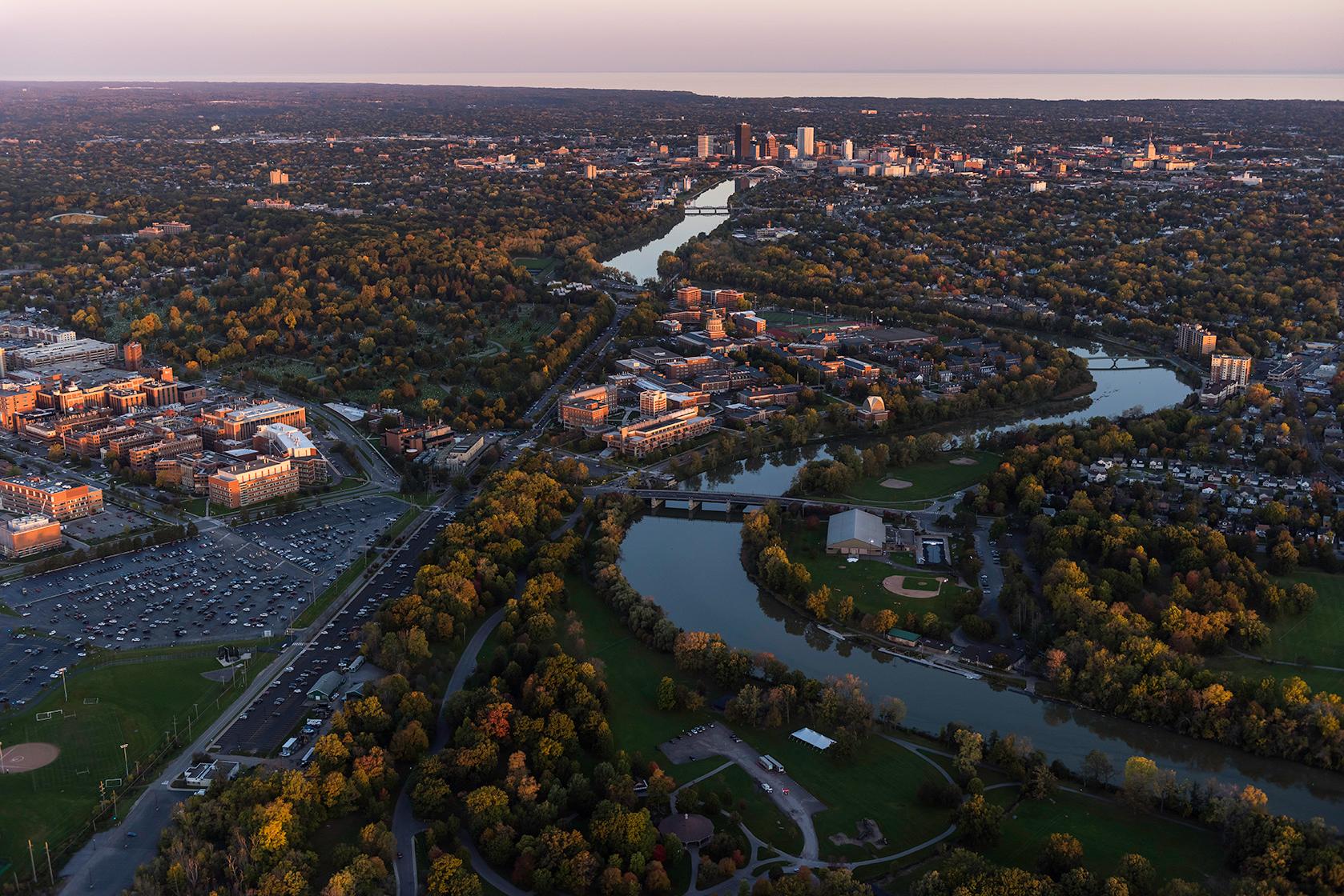 Aerial photo of University of Rochester's River Campus and Medical Center along with downtown Rochester, NY in in the evening